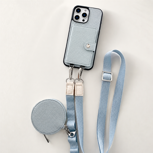 A pale blue pebbled phone case lies on cream with a snap-closed rear wallet, long adjustable strap and matching round zippered pouch.