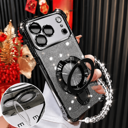 A hand holds a silver-glitter case with black glossy trim and an opened circular ring stand indoors, with a clear bead wrist loop and a small stand-detail inset.
