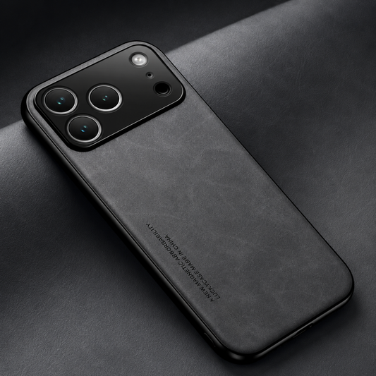 A dark gray mottled leather-look case rests across a matching material roll, showing its broad black camera panel and slim black borders.