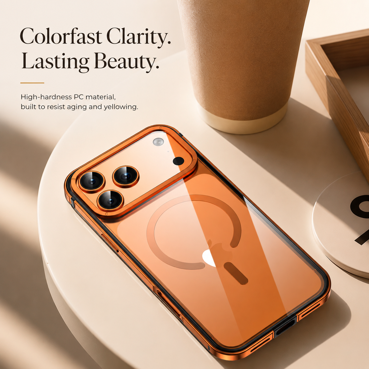 An orange clear-backed phone case lies on a cream table beside a paper cup. Text advertises hard PC material that resists aging and yellowing.