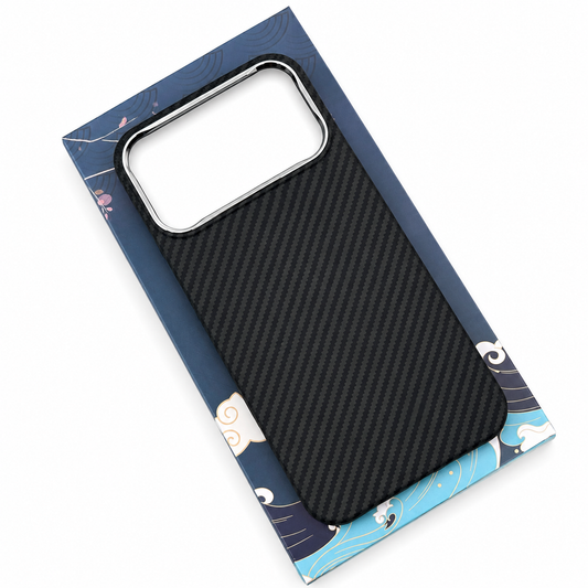 A black diagonal woven phone case rests on a blue illustrated box, showing its patterned back and wide rectangular camera opening with a silver-colored border.