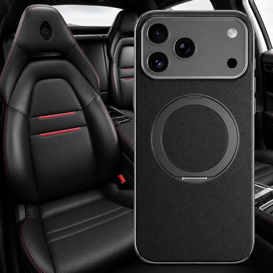 A black textured ring case is enlarged in front of a black sports-car seat with red accents.