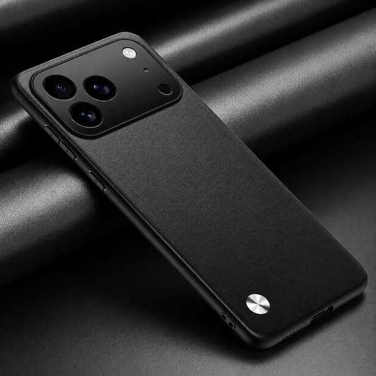 Black textured phone case lying diagonally on dark folded fabric, with a wide camera panel and small silver circular accent.