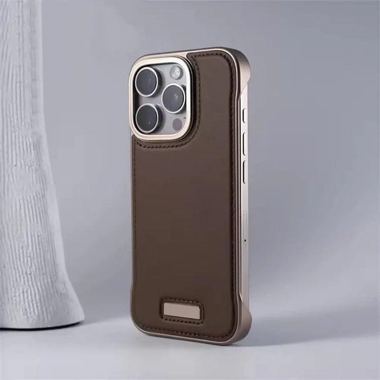 A brown leather-look phone case stands beside a white textured vase. Matching stitching borders its back, gold-colored trim surrounds the cameras, and a small rectangular plaque sits near the bottom.