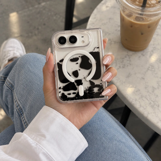 iPhone Duo Clear Magnetic Liquid Quicksand Case, Ink Splash Design with Wireless Charging . Image showing cow print phone at the cafe.