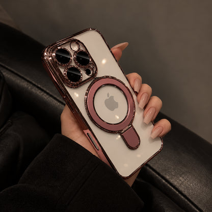 A hand holding a white iPhone case with a rose gold metallic MagSafe ring and a matching metallic camera bumper, set against a dark leather background.