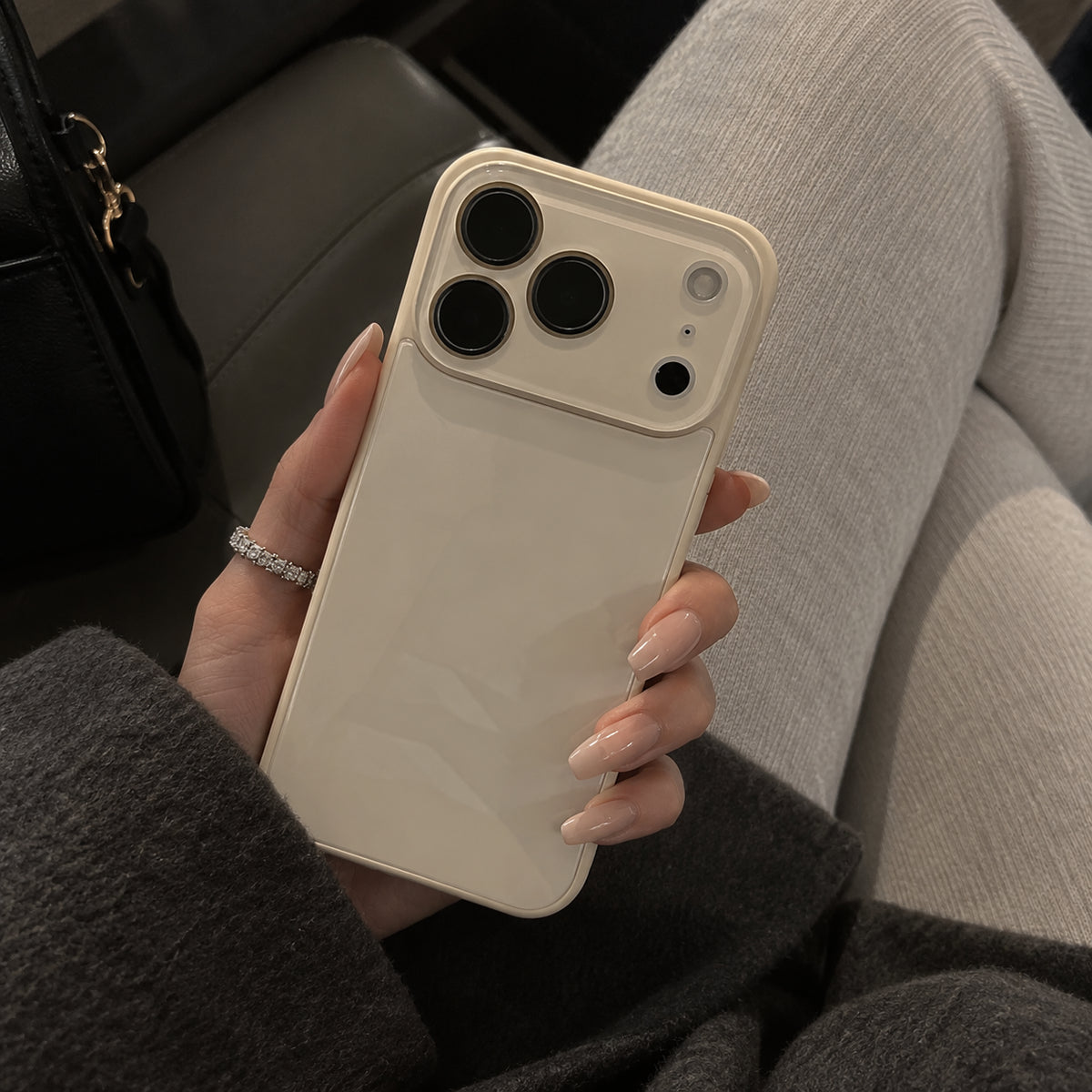 Image showing elegant Hand Holding Cream Smartphone, featuring iphone slim shockproof case with tempered glass back & camera protection.