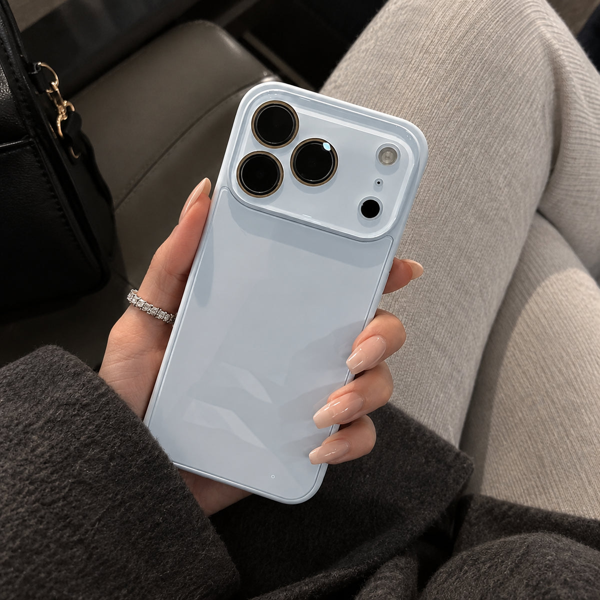Image showing glossy Blue Phone in Cozy Lounge, featuring iphone slim shockproof case with tempered glass back & camera protection.