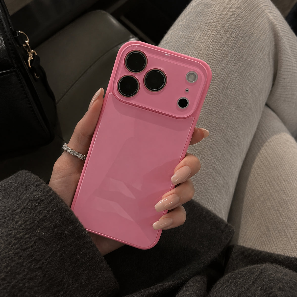 Image showing glossy Pink Phone in Hand, featuring iphone slim shockproof case with tempered glass back & camera protection.