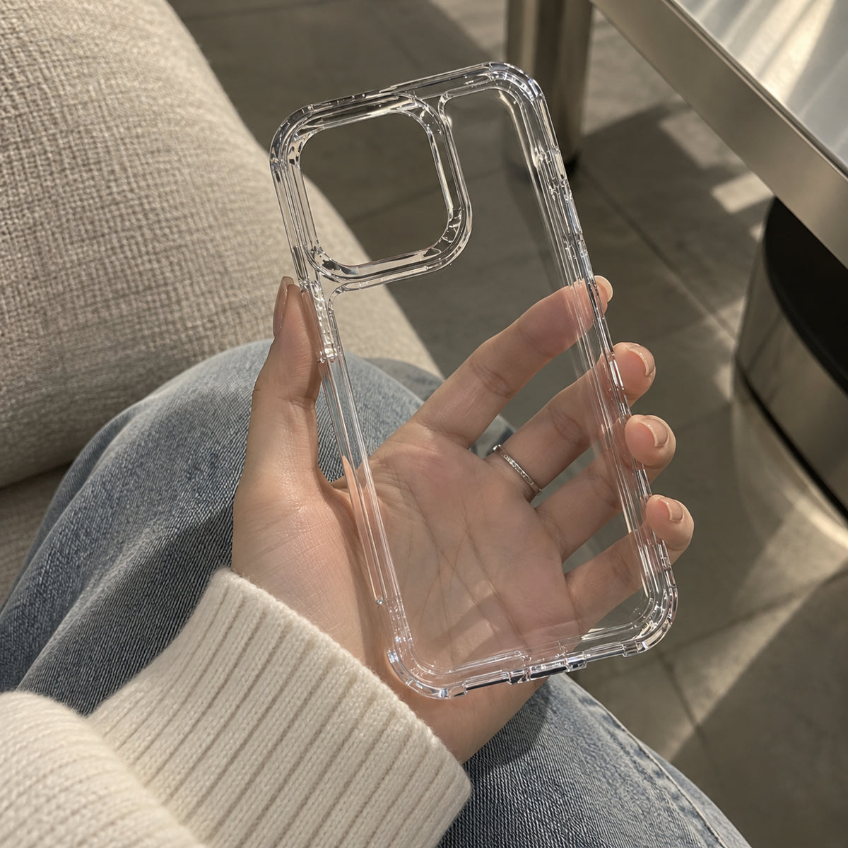 Image of iphone 18 clear shockproof case, showing handholdingaclearphonecase.