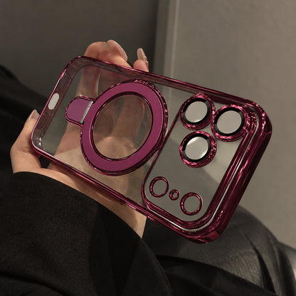 A person holds a transparent phone case with a metallic magenta-pink bumper and matching circular ring detail, shown close-up against a dark indoor background.