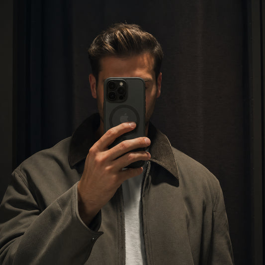 Image showing moody Mirror Selfiein Dark Tones, featuring iphone matte translucent magsafe case with camera lens protection & non-slip grip.
