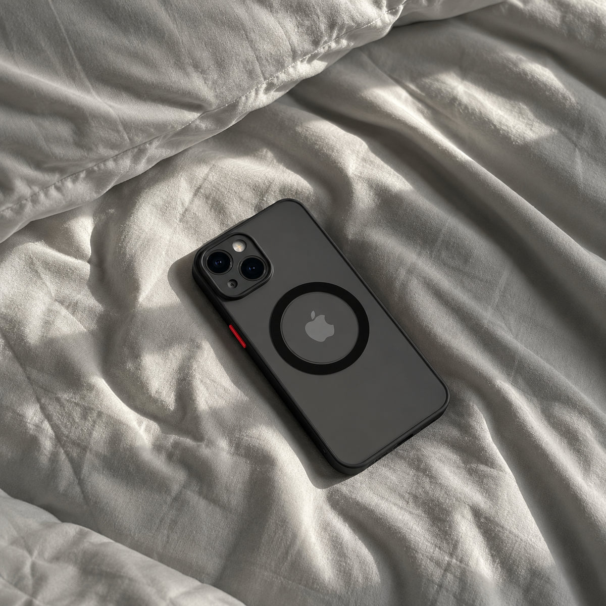 Image showing phone on Wrinkled Bedding, featuring iphone hard matte magsafe case with anti-fingerprint finish & slim protection.