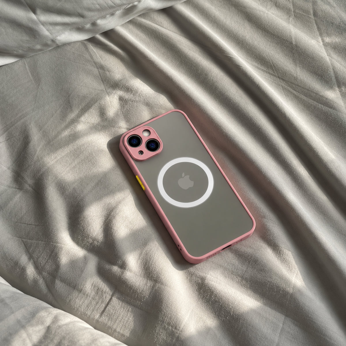 Image showing pink Mag Safe i Phone on Rumpled Bedding 1, featuring iphone hard matte magsafe case with anti-fingerprint finish & slim protection.