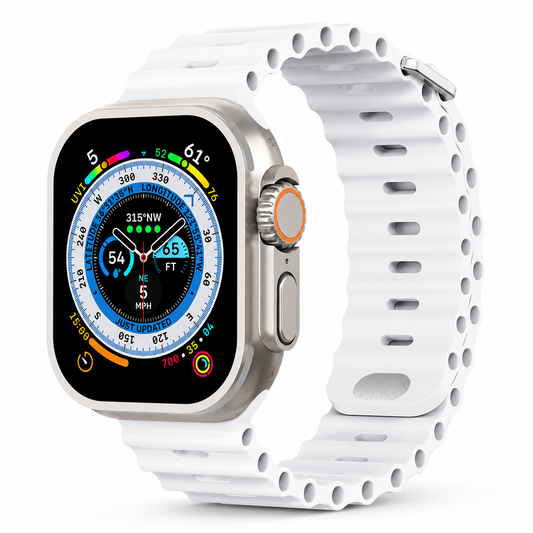 A silver-colored smartwatch with a colorful compass-style face is fitted with a white ribbed band against white. Oval adjustment holes and hollow channels run along the strap, with a silver-colored fastening loop.