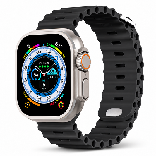 A silver-colored smartwatch with a colorful compass-style face is fitted with a black ribbed band against white. Oval adjustment holes and hollow channels run along the strap, with a silver-colored fastening loop.