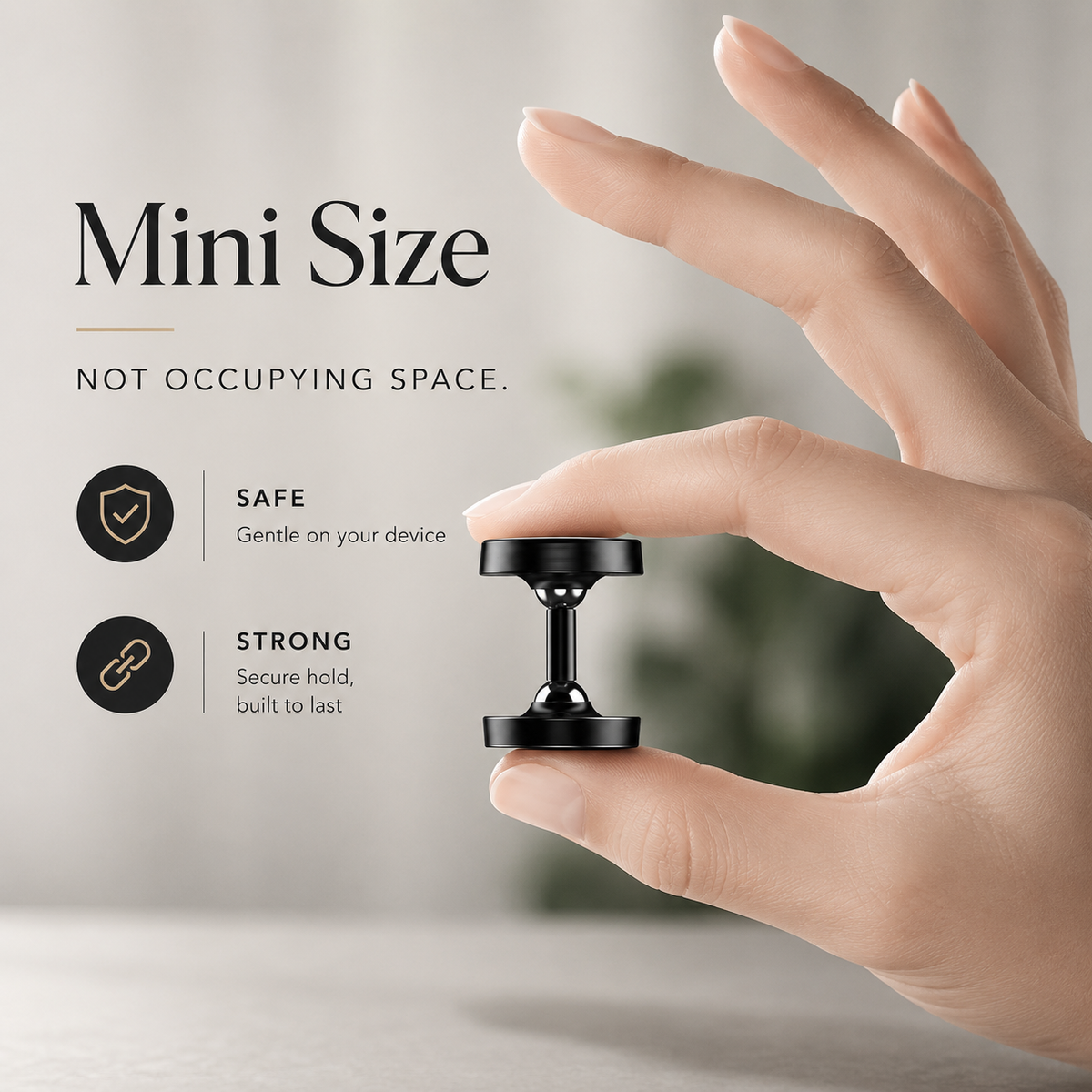 A person pinches a compact black magnetic phone mount between thumb and index finger against a pale background. Its small circular face sits above a short jointed stem and flared base, demonstrating the mount's size.
