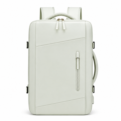 A pale green rectangular backpack faces forward, showing diagonal front seams, a narrow vertical zip pocket, double main zipper, woven top and side handles and padded shoulder straps.