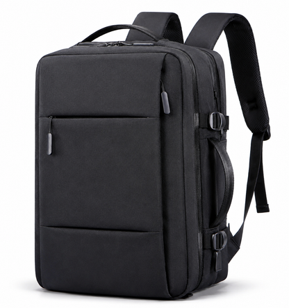 A black rectangular backpack stands at an angle with padded straps, top handle, front zipper pocket, side carry handle and two compression buckles.