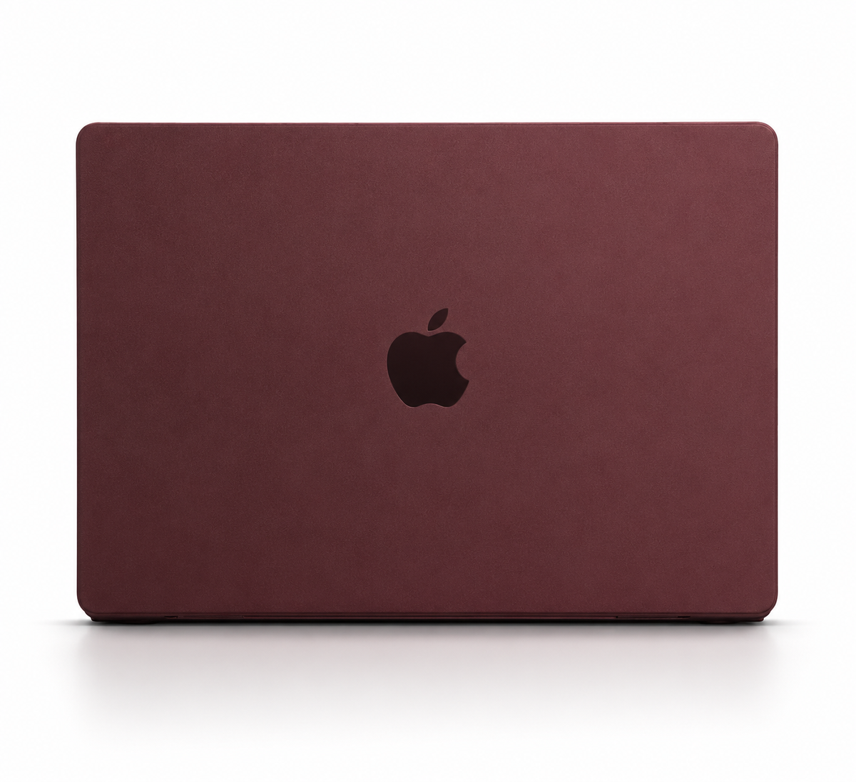 A closed MacBook is shown from behind in a matte burgundy fitted cover, with a dark Apple logo centered on the lid.