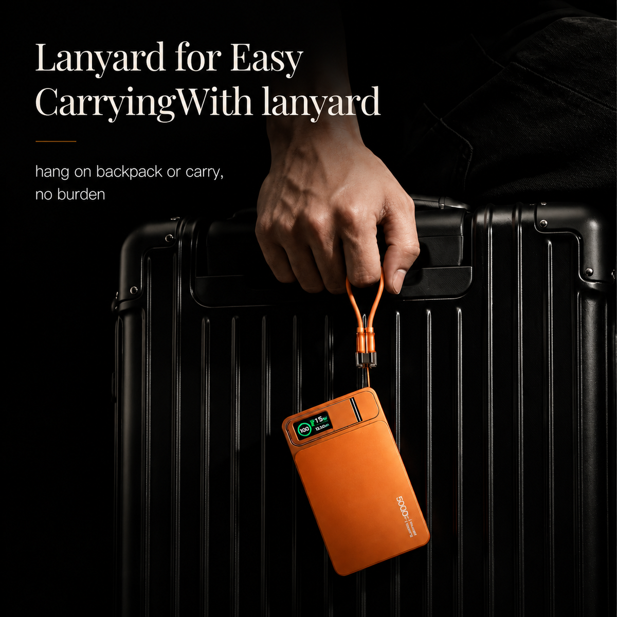 A hand grips an orange cable loop, suspending the orange power bank against a black suitcase. Text describes using the lanyard for carrying.