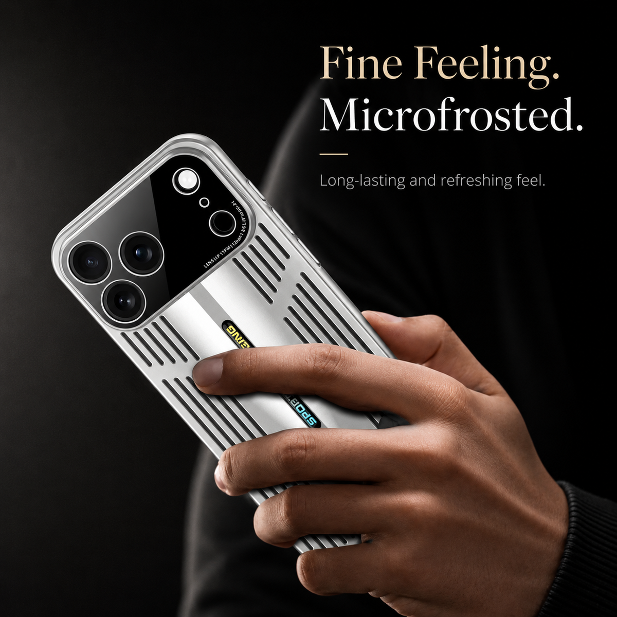 A hand holds a silver slotted case against black with a finger resting on the back. Text advertises a microfrosted feel.