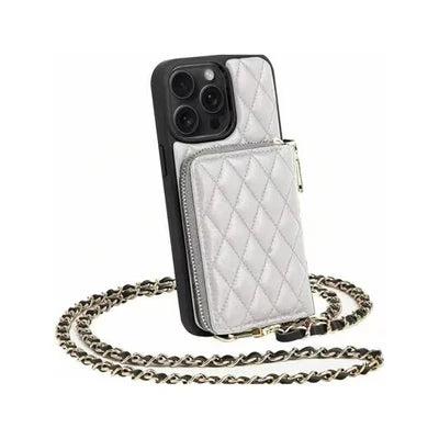 White quilted phone wallet case displayed upright with a raised zippered pocket. A gold-colored chain woven with dark material lies looped beneath the case.