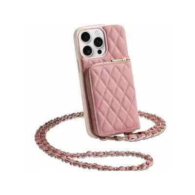 Pale pink quilted phone wallet case displayed upright with a raised zippered pocket. A gold-colored chain woven with pink material lies looped beneath it.