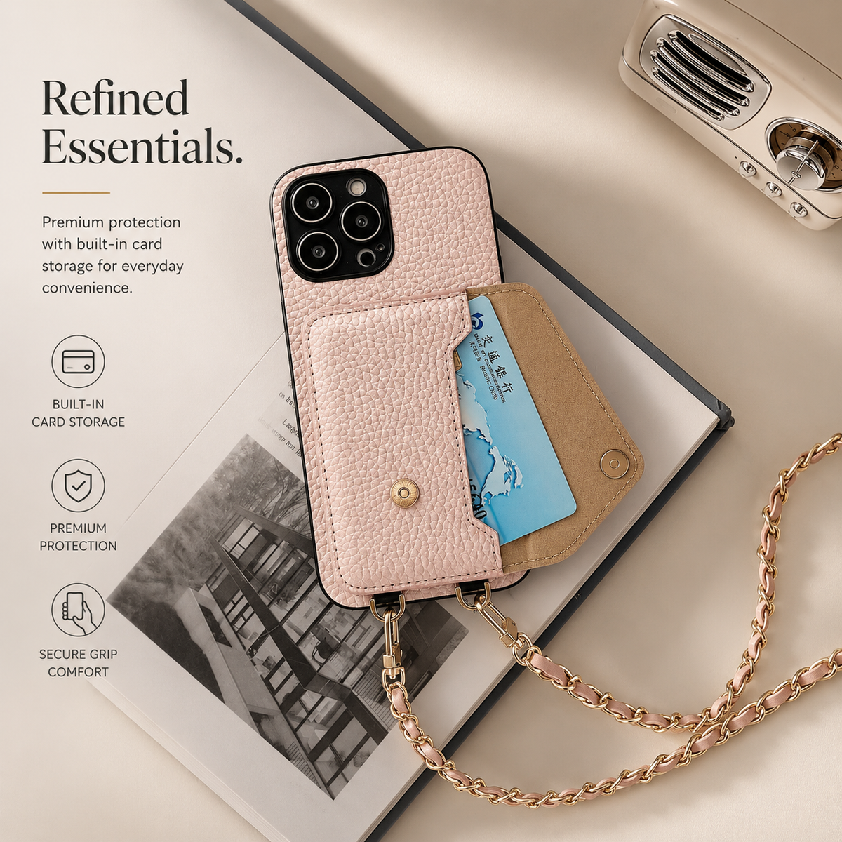 Pink phone wallet lies on a book with a blue card exposed in its opened rear pocket. Its woven chain curls across the beige surface beside storage text.