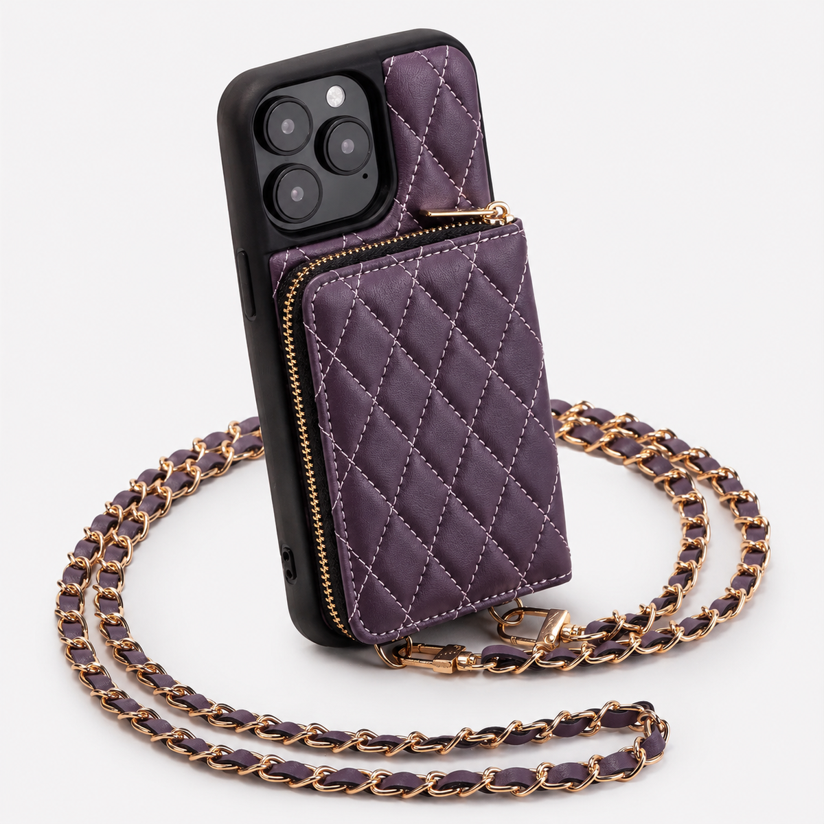 A purple diamond-quilted wallet phone case stands against white, with black phone edges, a gold-colored zipper around its rear pouch and a purple woven chain strap.
