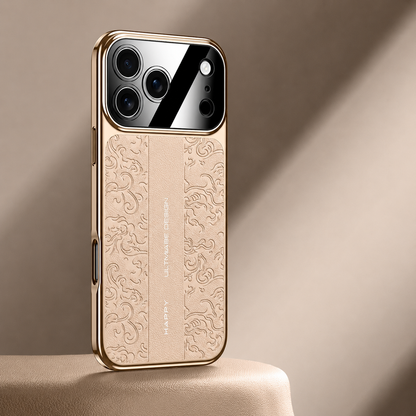 A beige embossed case with gold-colored edges stands on a warm pale pedestal. Decorative curls run beside a plain central strip with small vertical lettering.