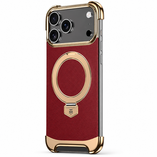 A burgundy textured phone case stands on white with gold-colored corner bumpers and a large circular ring folded flat below a broad camera panel.