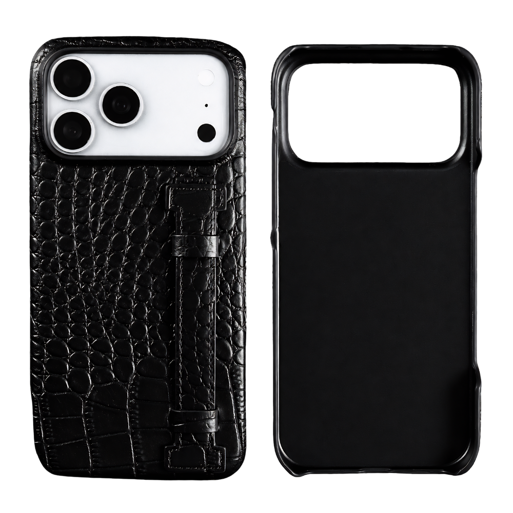 A black crocodile-style textured case stands beside its empty shell on white. A narrow matching strap runs vertically down the back beneath the broad camera opening.