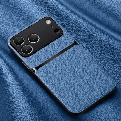 A blue pebbled leather-look phone case rests on matching blue material, with black edges, a glossy stripe and broad black camera panel.