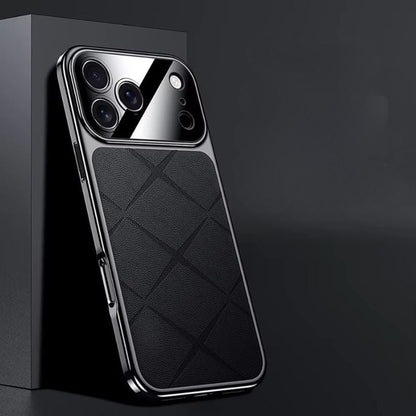 Black diamond-pattern phone case leaning against a dark display block, with reflective edging and a glossy camera panel.