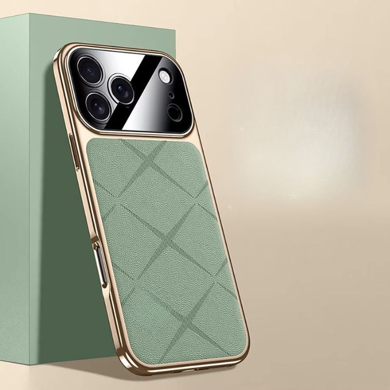 Pale green diamond-pattern phone case leaning against a green block, with gold-colored edging and a glossy camera panel.