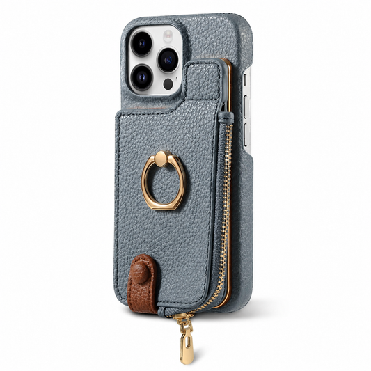 A gray pebbled wallet phone case stands upright on white with its rear facing forward. A raised rectangular zippered compartment fills most of the back below the camera, with a gold folding finger ring at its center. A small brown snap tab closes near the bottom, and a gold zipper pull hangs beneath.