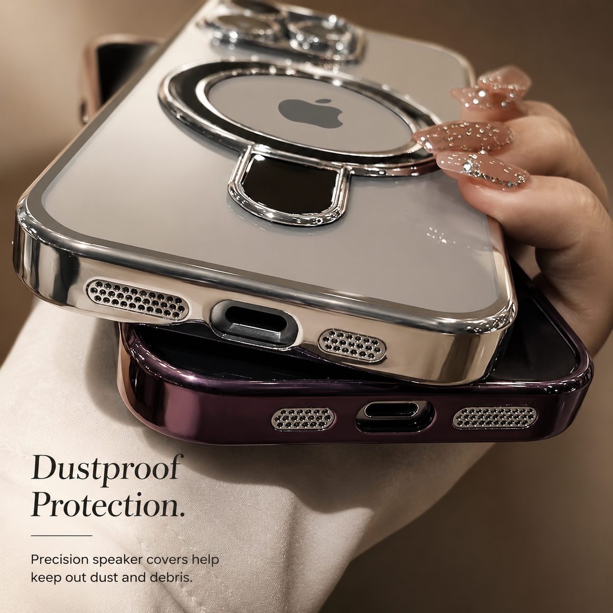 Two silver and purple clear cases are stacked in a hand with their bottom edges forward. Fine mesh-like speaker covers flank the charging openings.