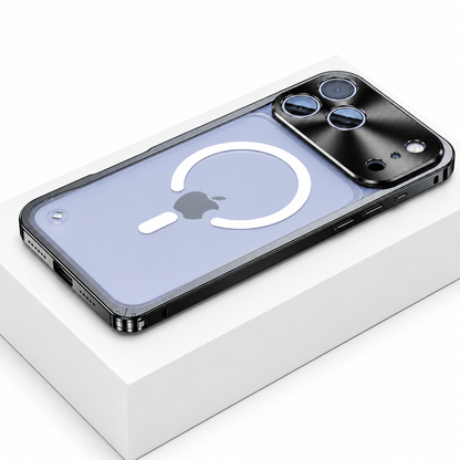 Black framed case lies face down on a white box, showing a frosted transparent back with a white broken magnetic ring and alignment bar. A broad reflective camera panel surrounds three lenses.