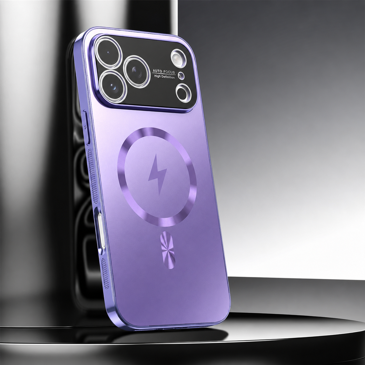 A purple metallic-looking phone case leans upright on a glossy black pedestal. A circular ring surrounds a lightning symbol beneath a broad black camera panel with silver-colored lens rings.