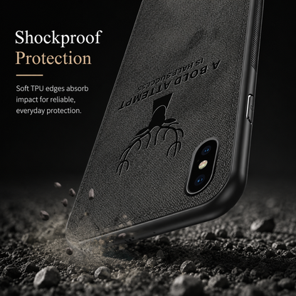 A black textured stag-design phone case strikes rocky ground corner-first. Text advertises shockproof protection and soft TPU edges that absorb impact.