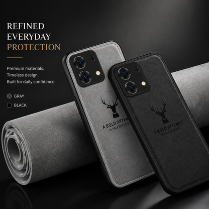 Gray and black fabric-textured phone cases lean against a rolled sheet of gray material. Each carries a stag head and motivational words. Text advertises materials, design and everyday protection.