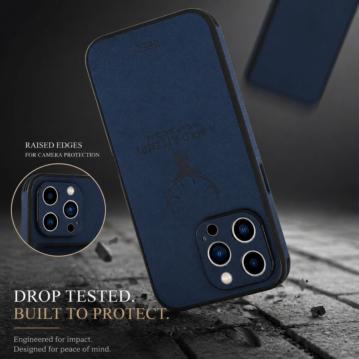 A blue stag-design phone case strikes gray ground corner-first amid fragments. An inset highlights its camera surround. Text advertises drop testing and raised camera edges.