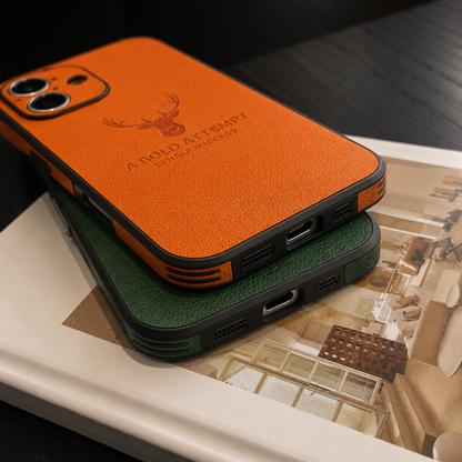 An orange case is stacked on a green case above an open magazine, showing their bottom charging-port cutouts and layered edges.