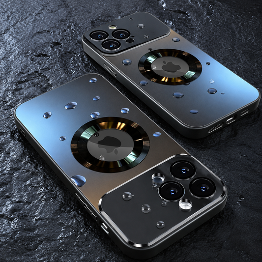 Two reflective graphite phone cases lie diagonally on wet dark stone. Water droplets cover their backs around large segmented rings, while mirror-like camera panels reflect the surroundings.