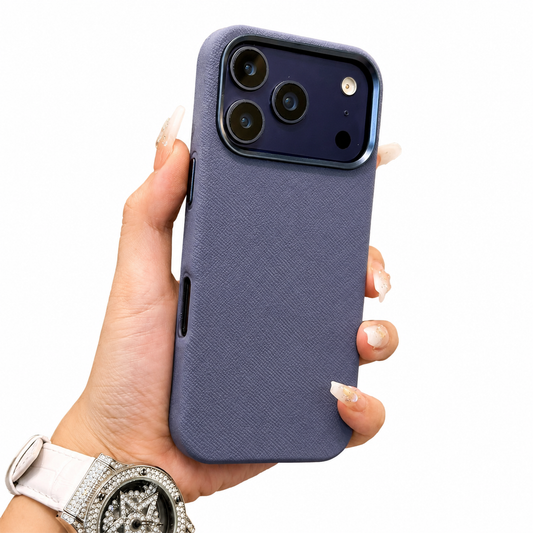A watch-wearing hand holds a slate-blue textured case upright on white. Its blue raised camera border frames three lenses, while the plain woven-looking back has no visible ring.