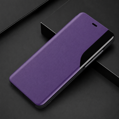 Purple flip phone case lying diagonally on dark blocks, with an earpiece slit and curved glossy black strip along the right edge.
