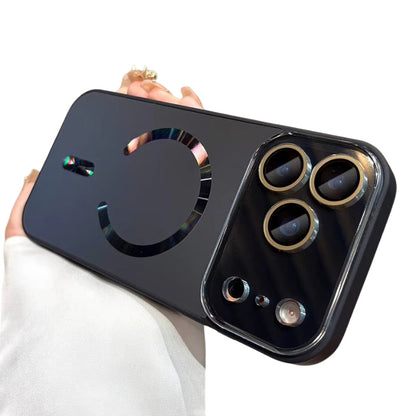 Hand holds a black case horizontally against white. A reflective rainbow-tinted magnetic ring and alignment bar decorate the back, with gold-colored rings around the camera lenses.