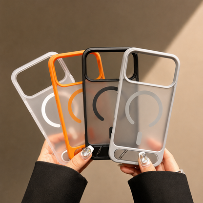 Hands fan out empty white, orange, dark and gray translucent cases, showing their camera openings and circular magnetic designs.
