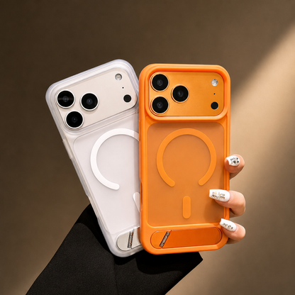 A hand holds white and orange cases side by side, showing their magnetic circles and wide camera openings.